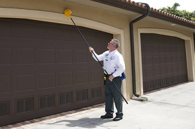 a safer homes tech inspecting a garage