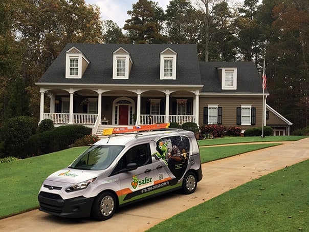 A Safer Home Services van in front of beautiful home