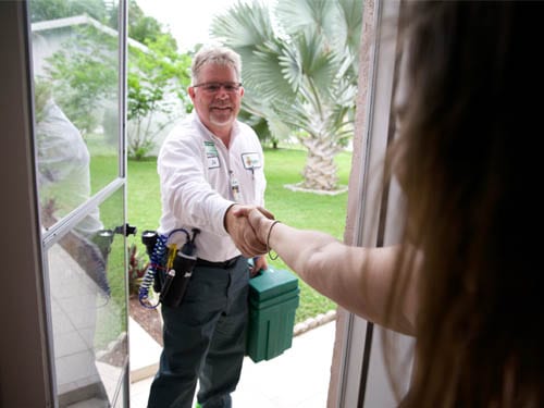 Safer Home Services technician greeting customer at front door